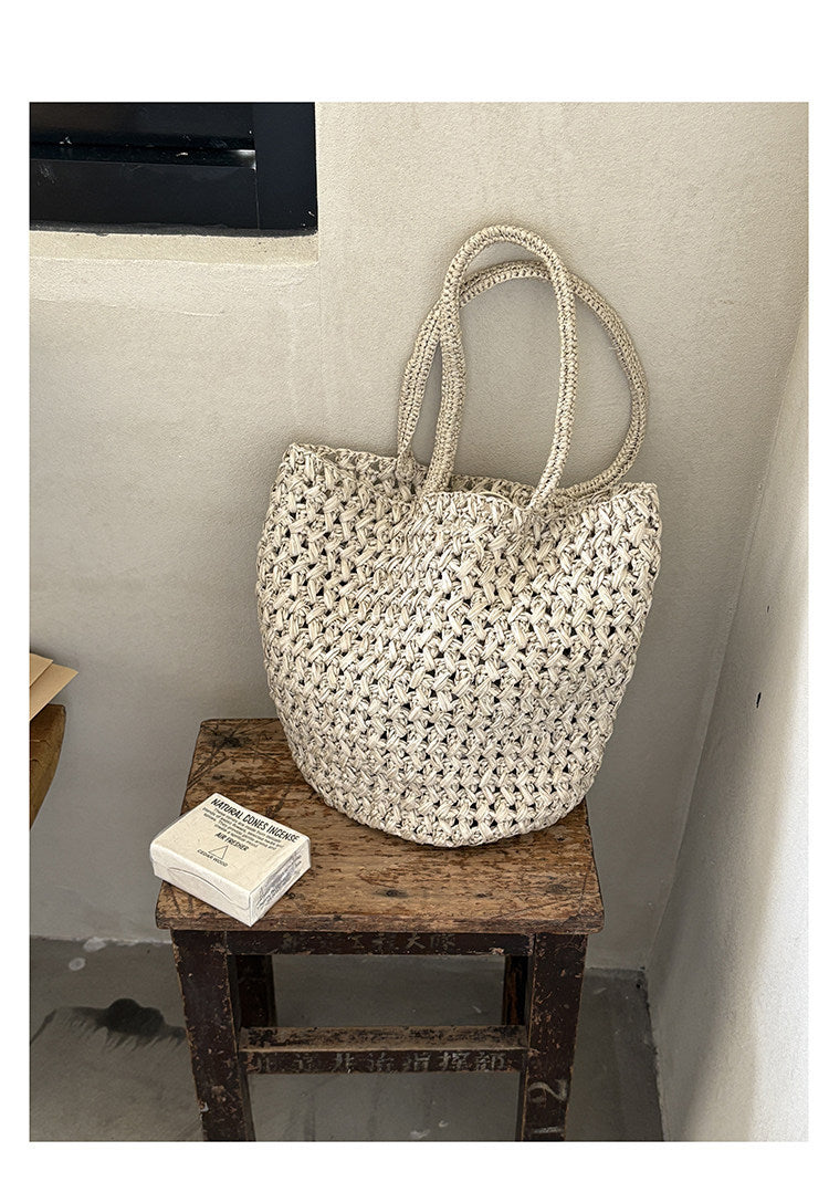 Close-up of natural handwoven raffia straw texture on tote bag