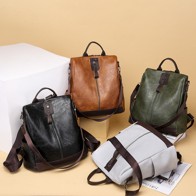Black anti-theft soft leather backpack with minimalist urban design for travel, shopping, and everyday use.