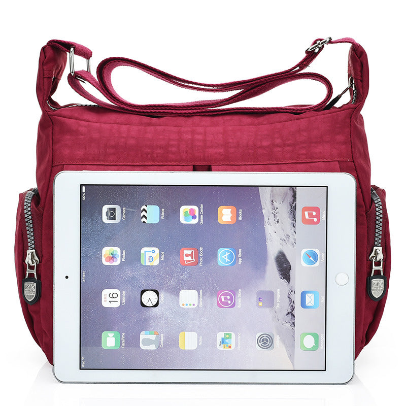 Black nylon crossbody handbag featuring a comfortable shoulder strap and casual design.