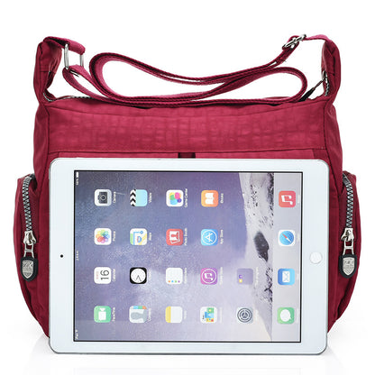 Black nylon crossbody handbag featuring a comfortable shoulder strap and casual design.