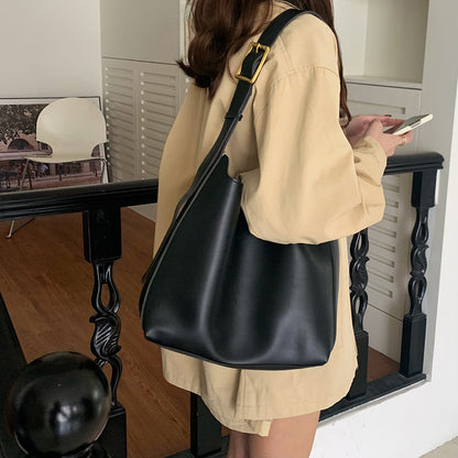 Stylish brown PU leather crossbody bag featuring a square vertical design and comfortable shoulder strap.