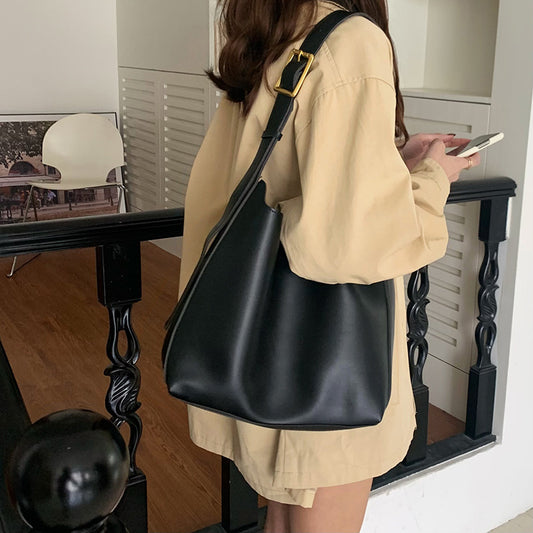 Stylish brown PU leather crossbody bag featuring a square vertical design and comfortable shoulder strap.