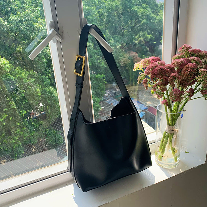 Trendy soft PU leather shoulder bag for women with modern minimalist styling.