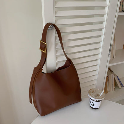 Spacious minimalist women's shoulder bag with interior pocket for organized daily storage.