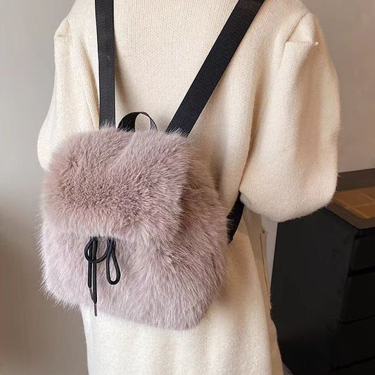 Women's soft plush backpack featuring a drawstring closure, hidden zipper pocket, and trendy patchwork streetwear style.