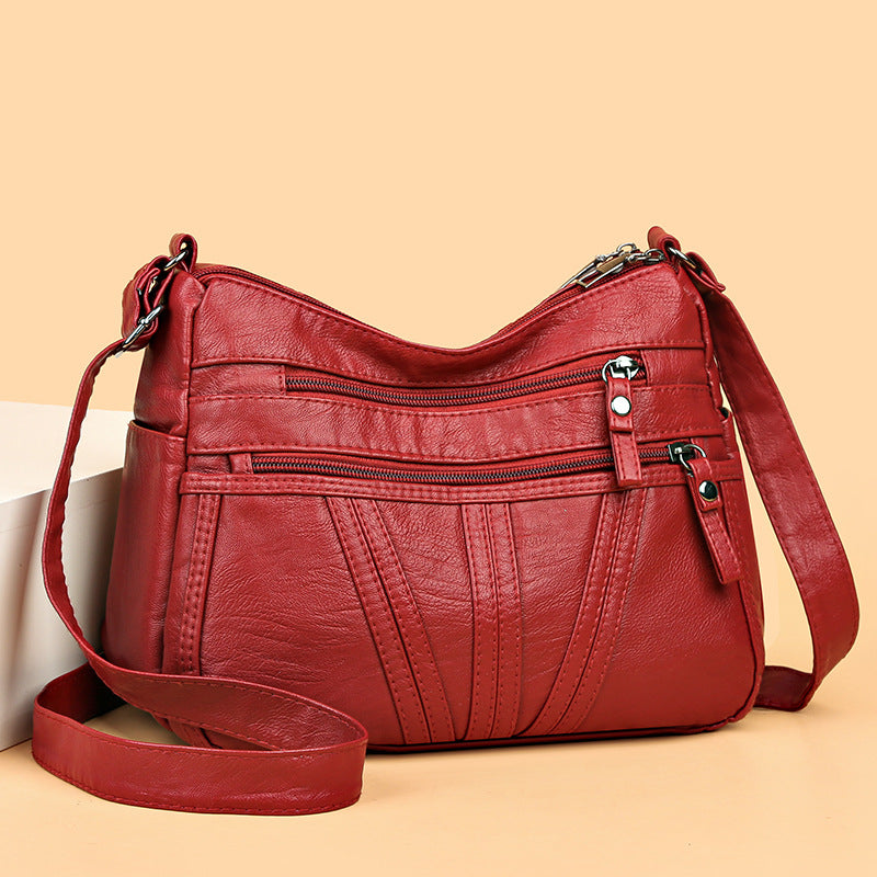 Single adjustable shoulder strap on soft washed-leather crossbody bag