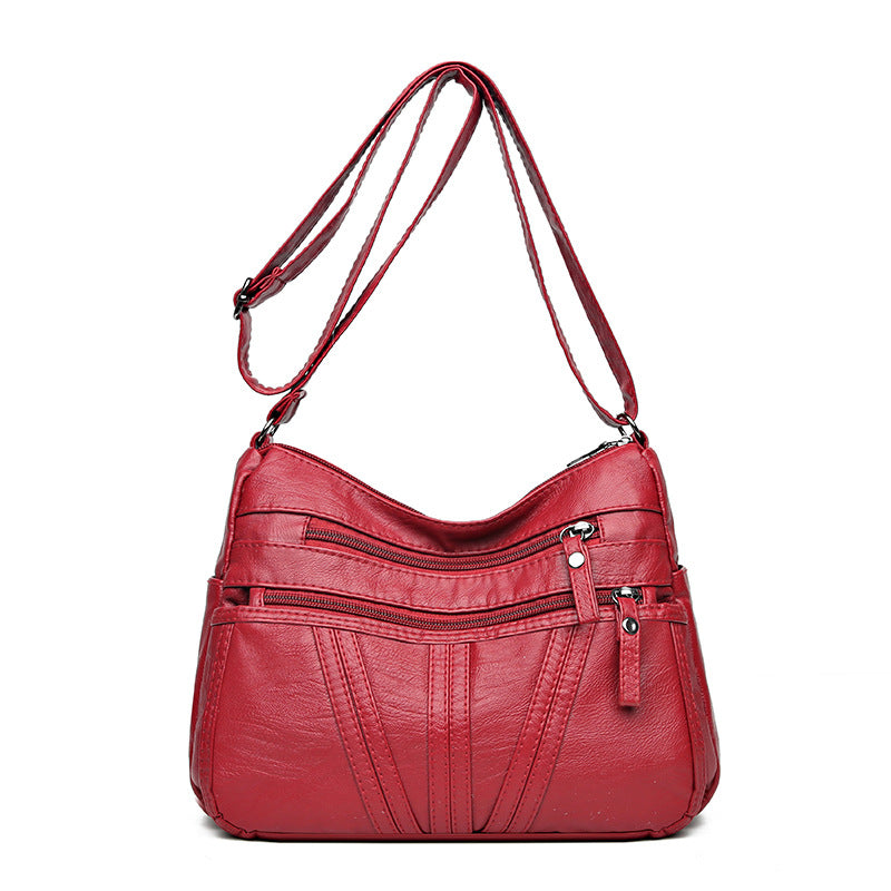Washed-leather crossbody bag available in black, red, and brown colors