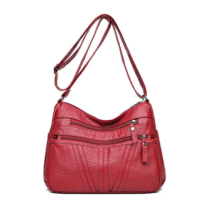Washed-leather crossbody bag available in black, red, and brown colors