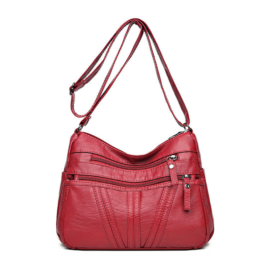 Washed-leather crossbody bag available in black, red, and brown colors