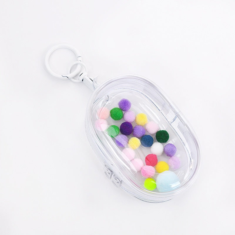 Person carrying clear doll backpack with collectible figures outdoors