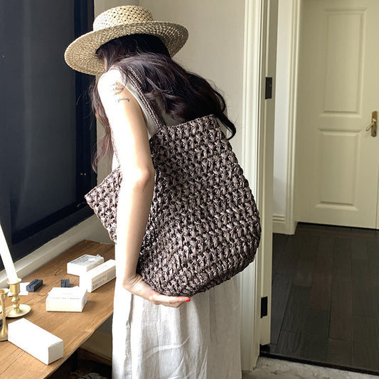 Handwoven raffia straw tote bag in light beige, front view