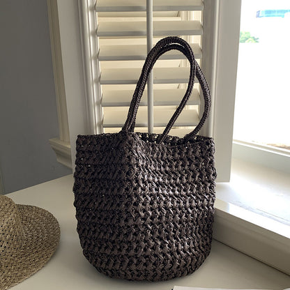 Soft bucket-shape raffia tote bag showing side silhouette