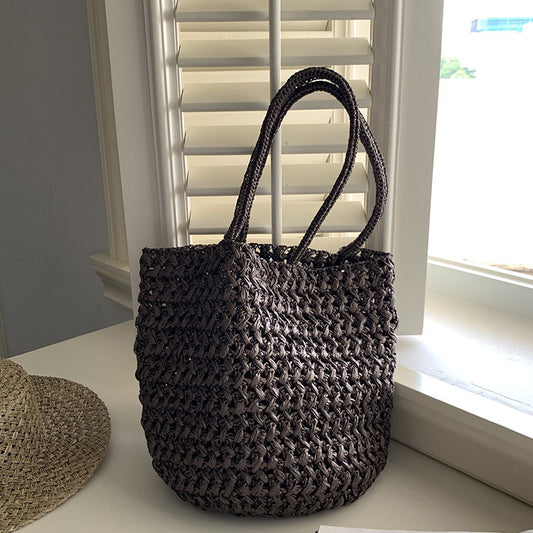 Soft bucket-shape raffia tote bag showing side silhouette