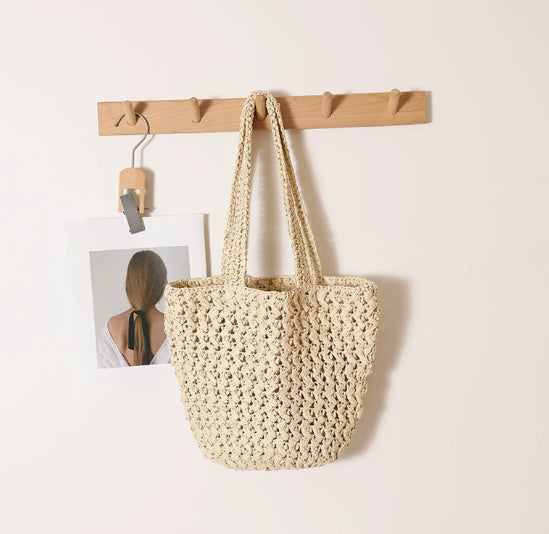 Three-dimensional outer pocket on woven raffia shoulder bag