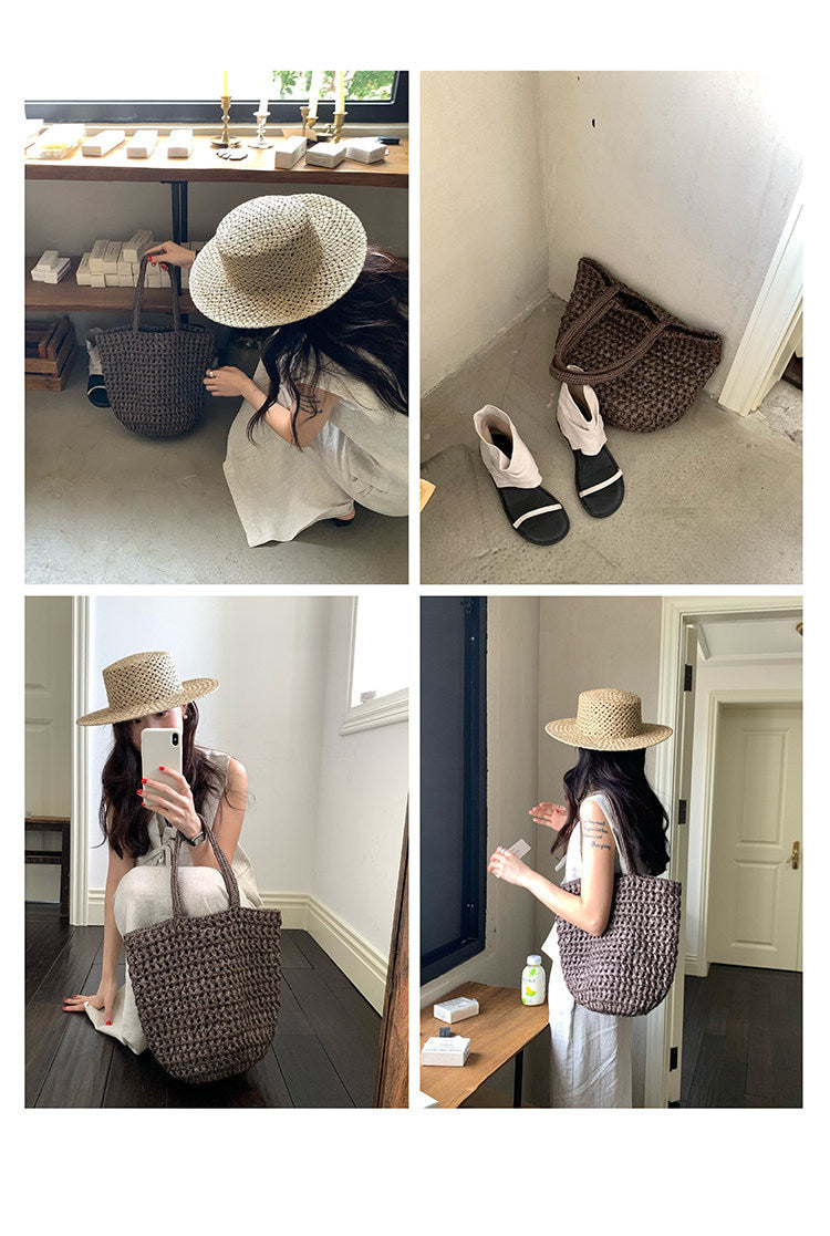 Woman carrying handwoven raffia tote bag styled with summer outfit
