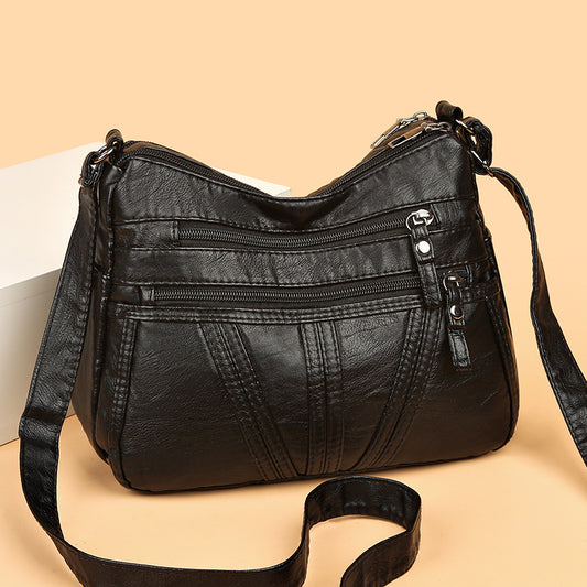 Soft washed-leather textured crossbody bag in black with single shoulder strap