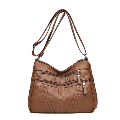 Woman wearing soft washed-leather crossbody bag as everyday accessory